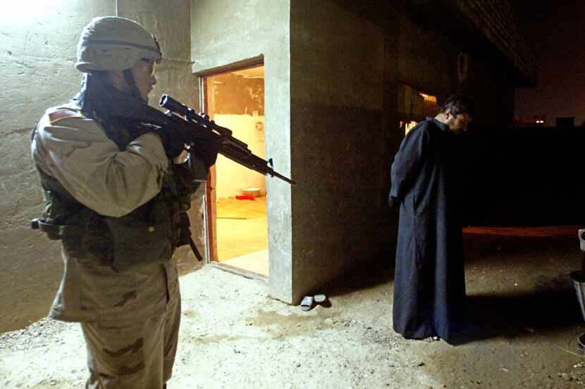 Lorenzo Zarate held an Iraqi insurgent at gunpoint during a Dec. 11, 2003, raid in Tikrit,...