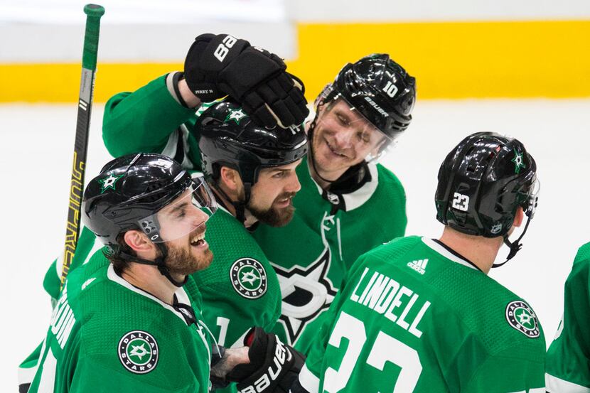 Dallas Stars celebrate a goal scored by left wing Jamie Benn (14) for a hat trick during the...
