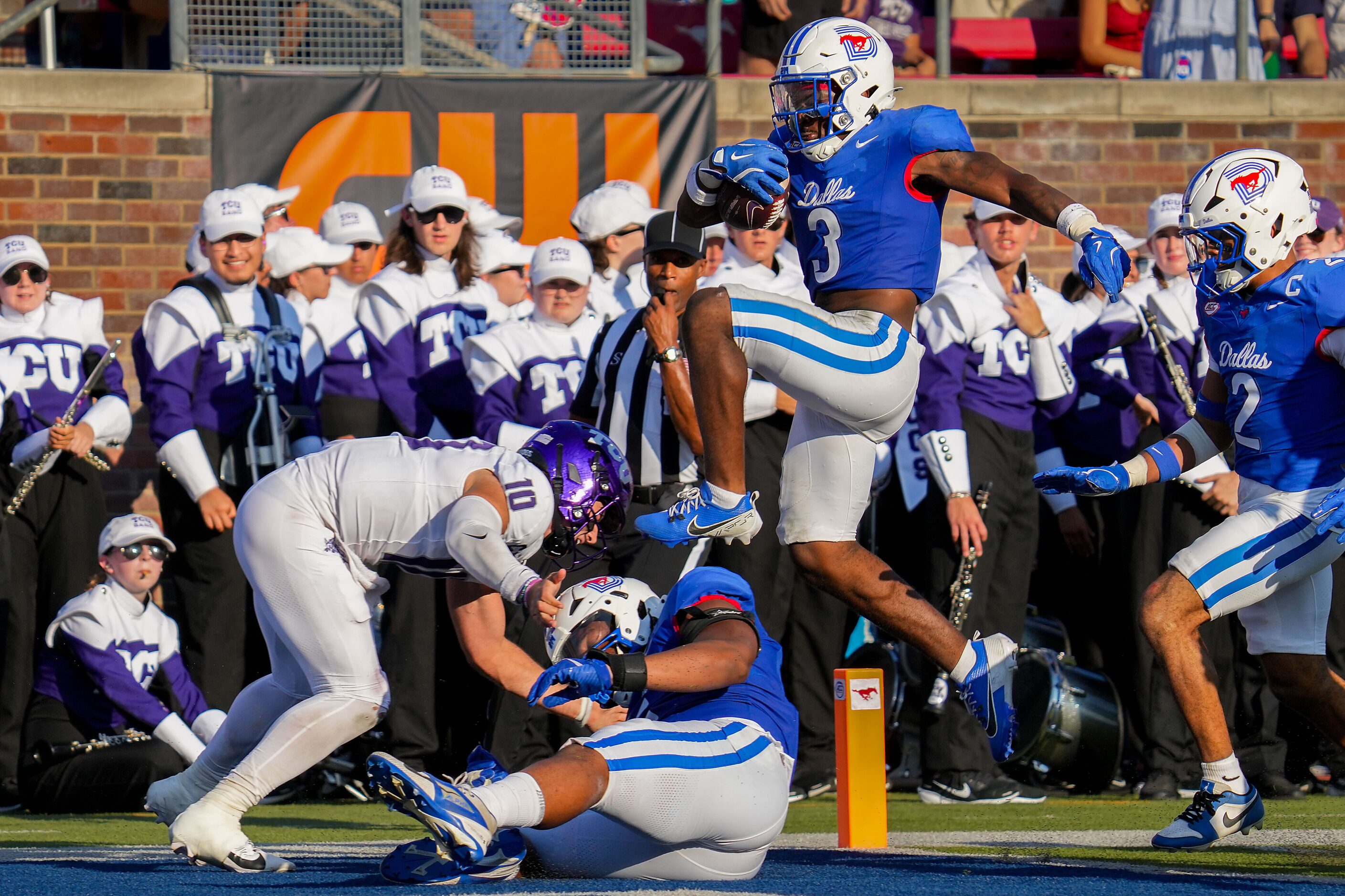 SMU safety Ahmaad Moses (3) leaps over TCU quarterback Josh Hoover (10) as he returns an...