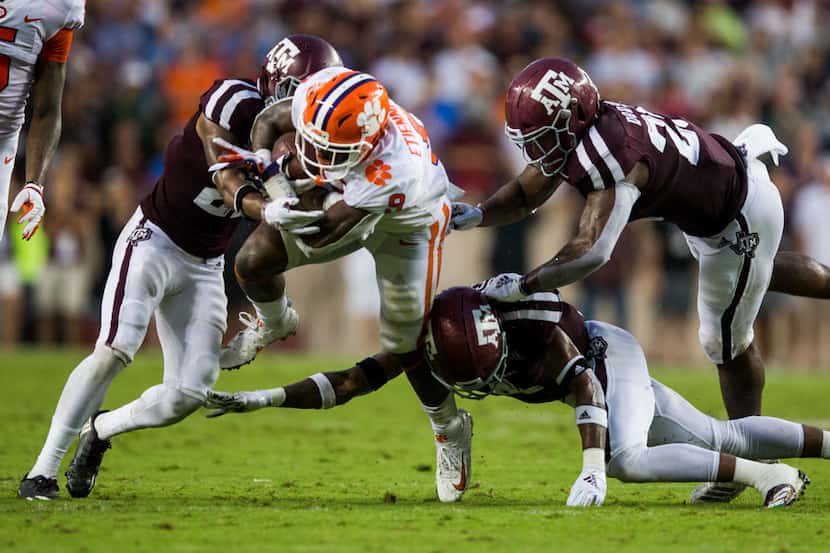 Clemson Tigers running back Travis Etienne (9) is tackled by Texas A&M Aggies defensive back...