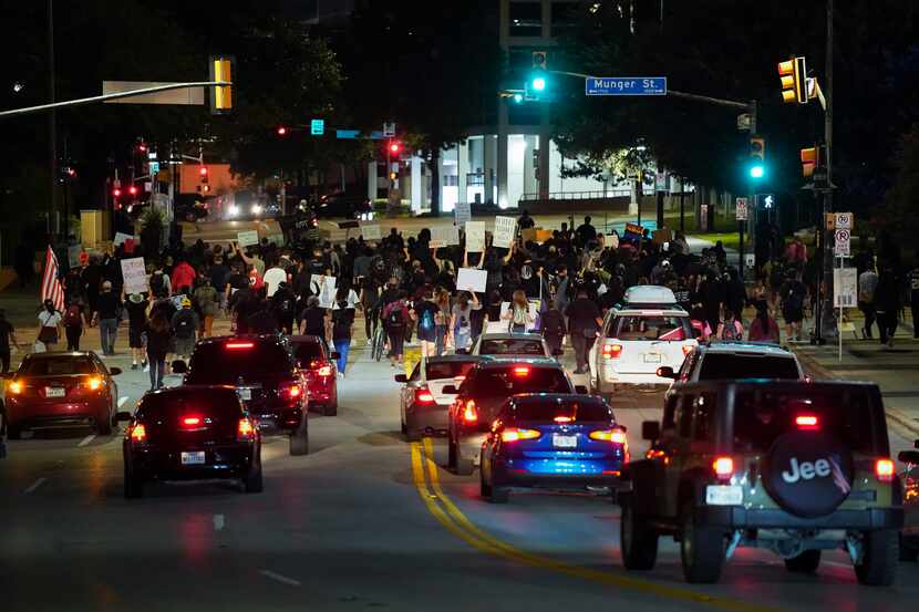 Traffic backs up as demonstrators march on Ackard Street in downtown Dallas after a Kentucky...
