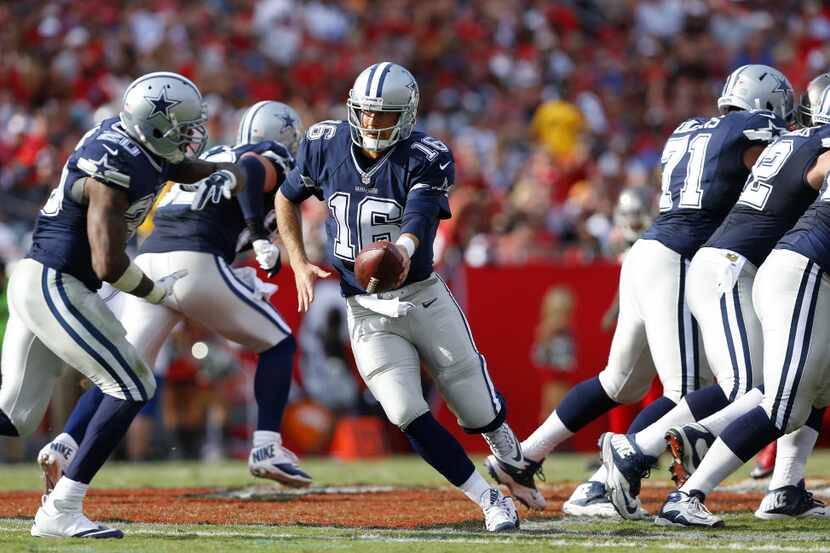 Dallas Cowboys quarterback Matt Cassel (16) hands the ball off to Dallas Cowboys running...