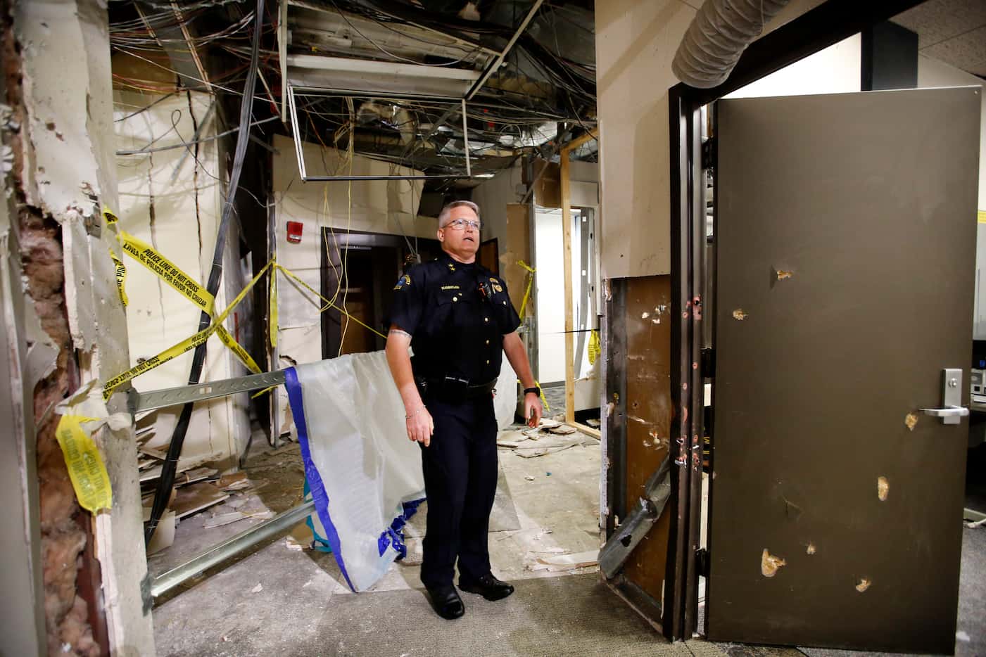 Dallas County College Police Chief Joseph Hannigan shows the spot where the gunman was...