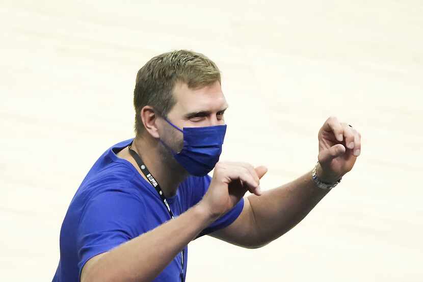 Dallas Mavericks great Dirk Nowitzki waves to fans as the teams warm up before Game 7 or an...