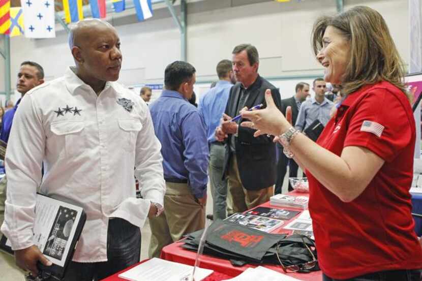 
 Illya Askew chatted with Leigh Hassell of Southwest Airlines during a job fair for...