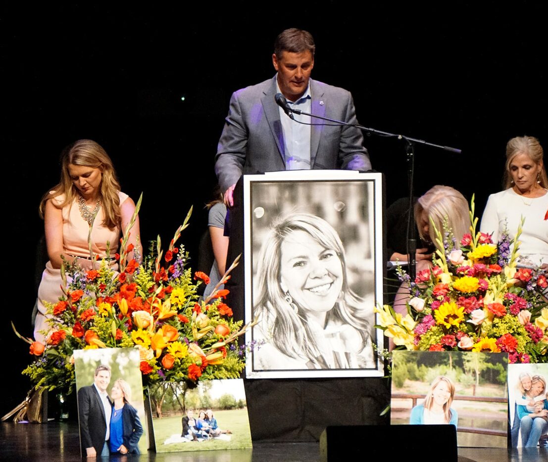 Michael Riordan, center, is joined by family members at a memorial service for his wife...