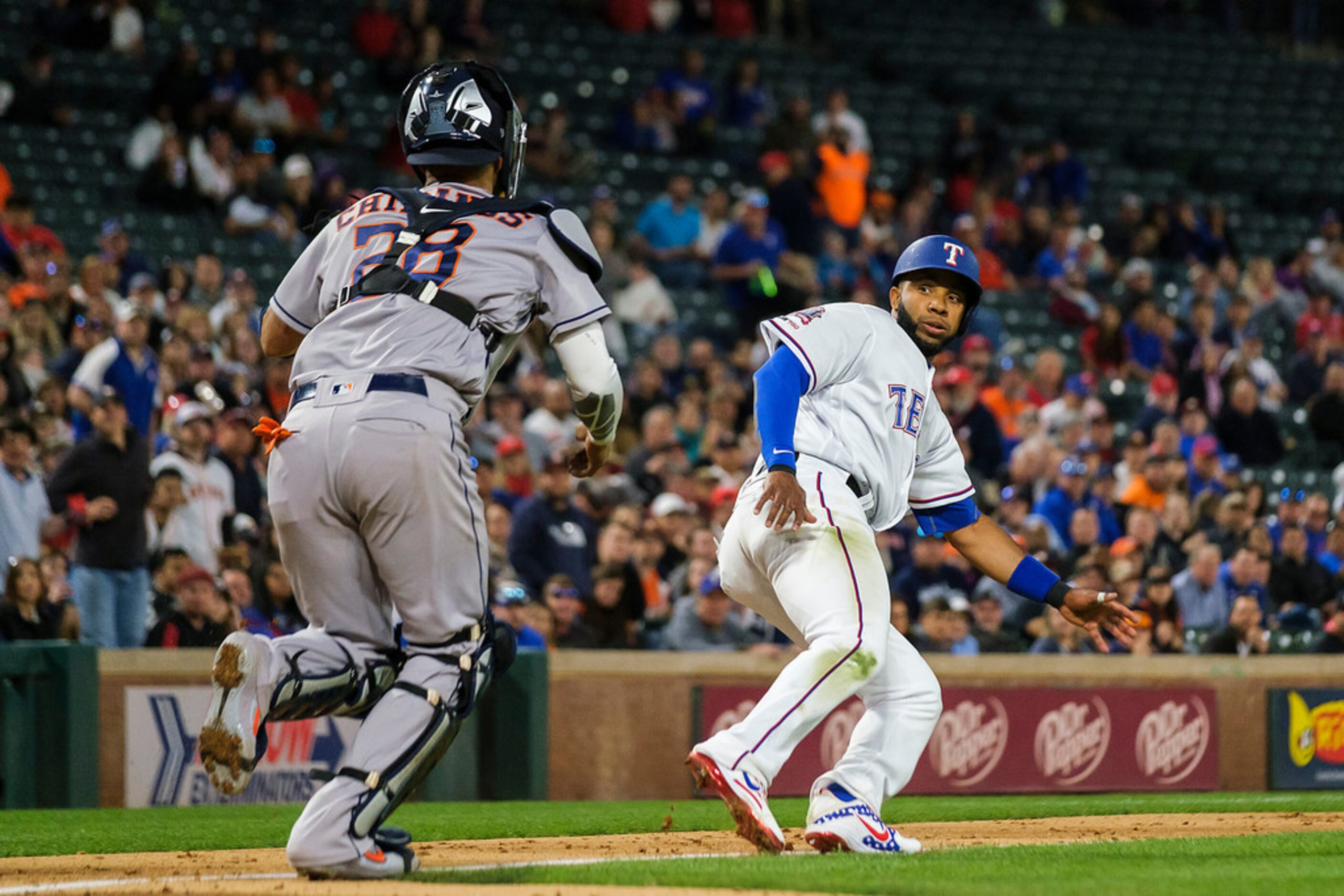 Texas Rangers shortstop Elvis Andrus is caught in a rundown trying to score on a groundout...