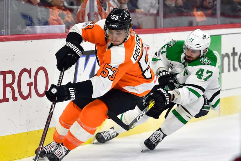 Philadelphia Flyers' Shayne Gostisbehere, left, skates past Dallas Stars' Alexander Radulov...