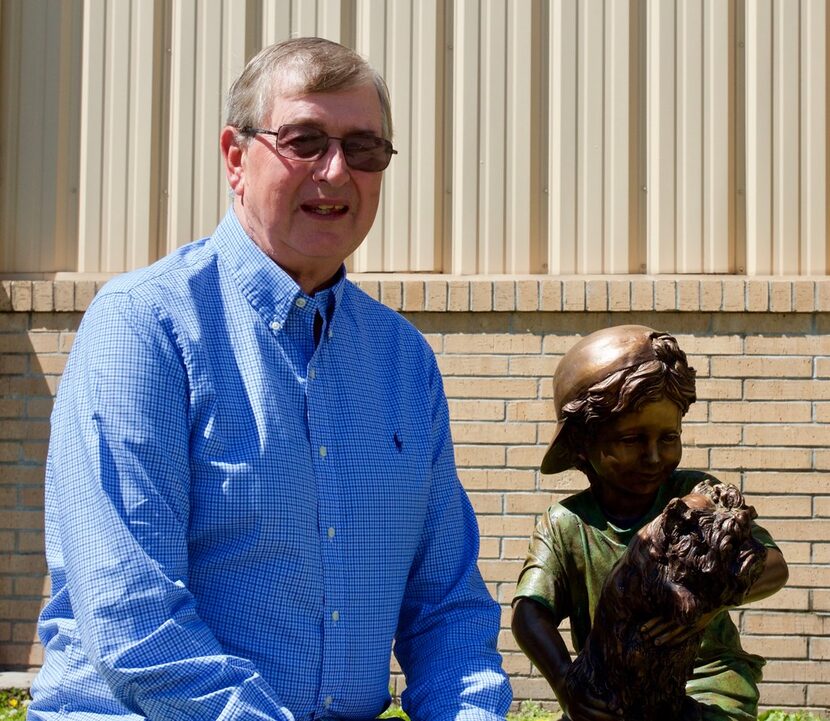 Jim with a sculpture that represents his grandfather, LeRoy "Hallie" Garwood, who was an...