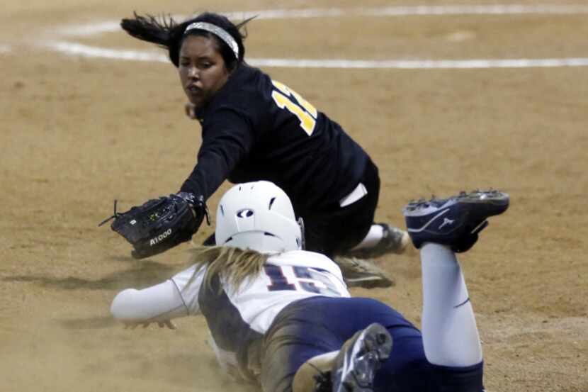 McKinney Boyd High School's Bailey Jo Jones slides into third base as Plano East High...