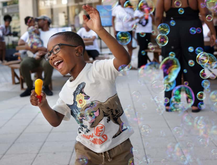 4-year-old Alexander Bronner plays with bubbles during a Daddy Stroller Social Club event at...