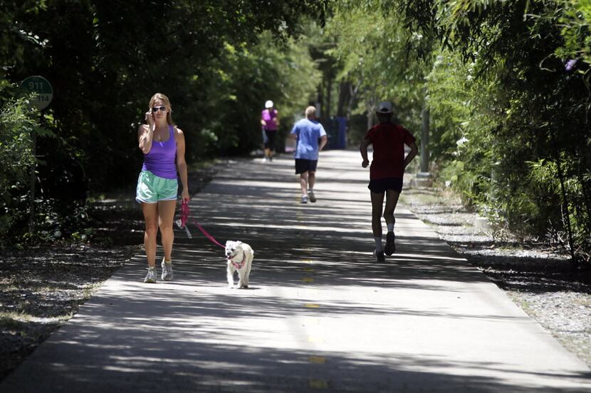 Chaney Shadrock walks her dog Maisey on the Katy Trail in Dallas. Shadrock keeps her walks...