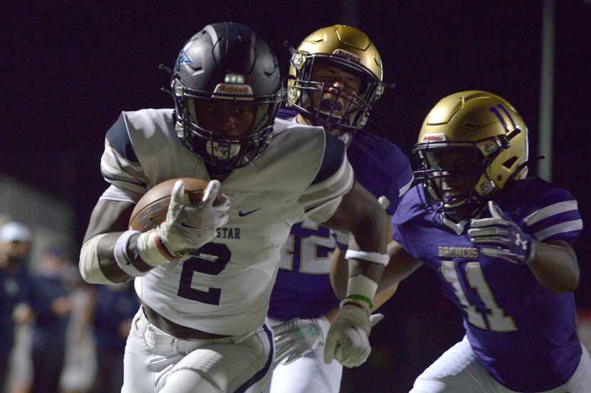 Lone Star’s Ashton Jeanty (2) runs for a touchdown in front of Denton’s Amir Fera (42) and...