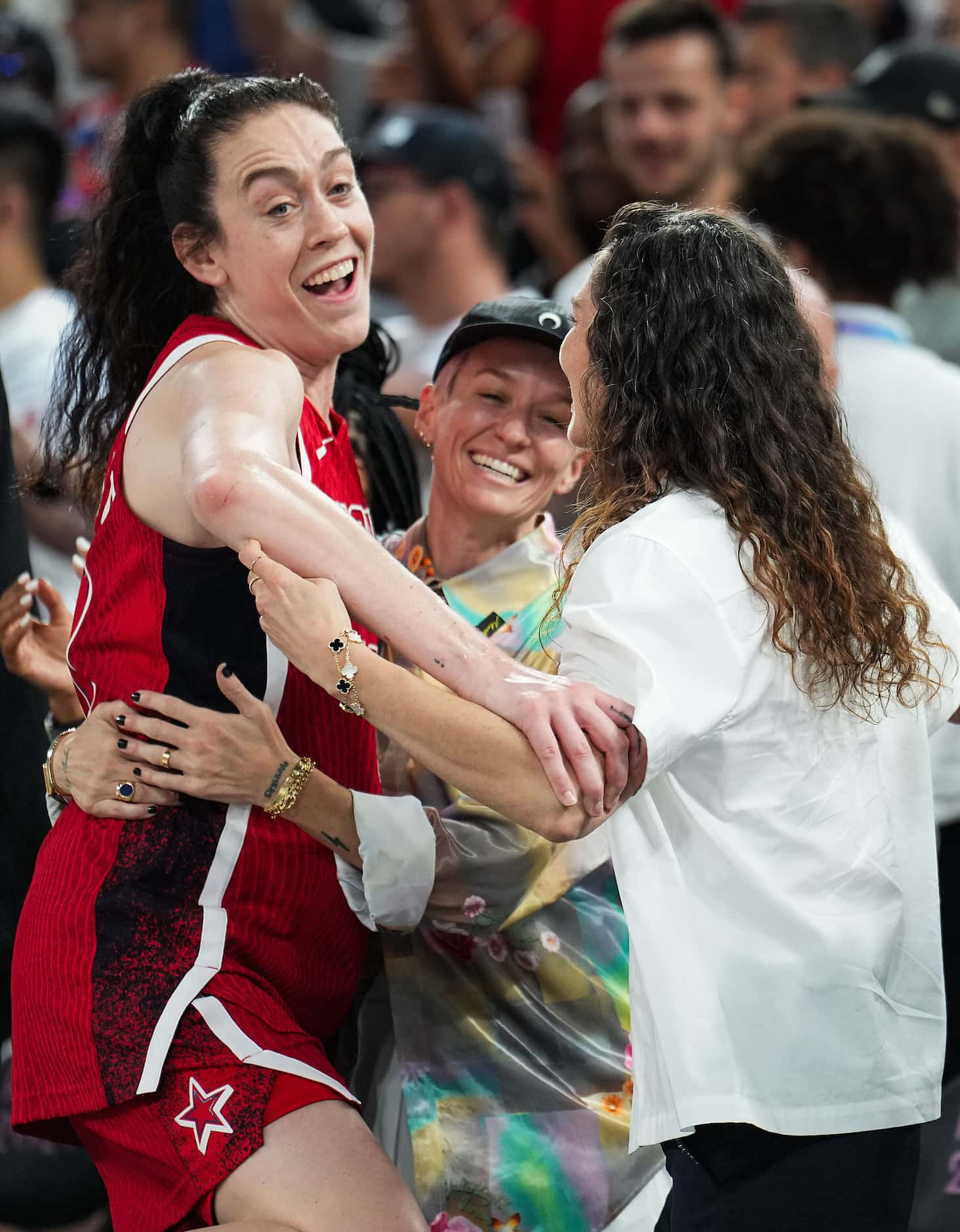 Breanna Stewart of the United States celebrates with Megan Rapinoe (center) and Sue Bird...