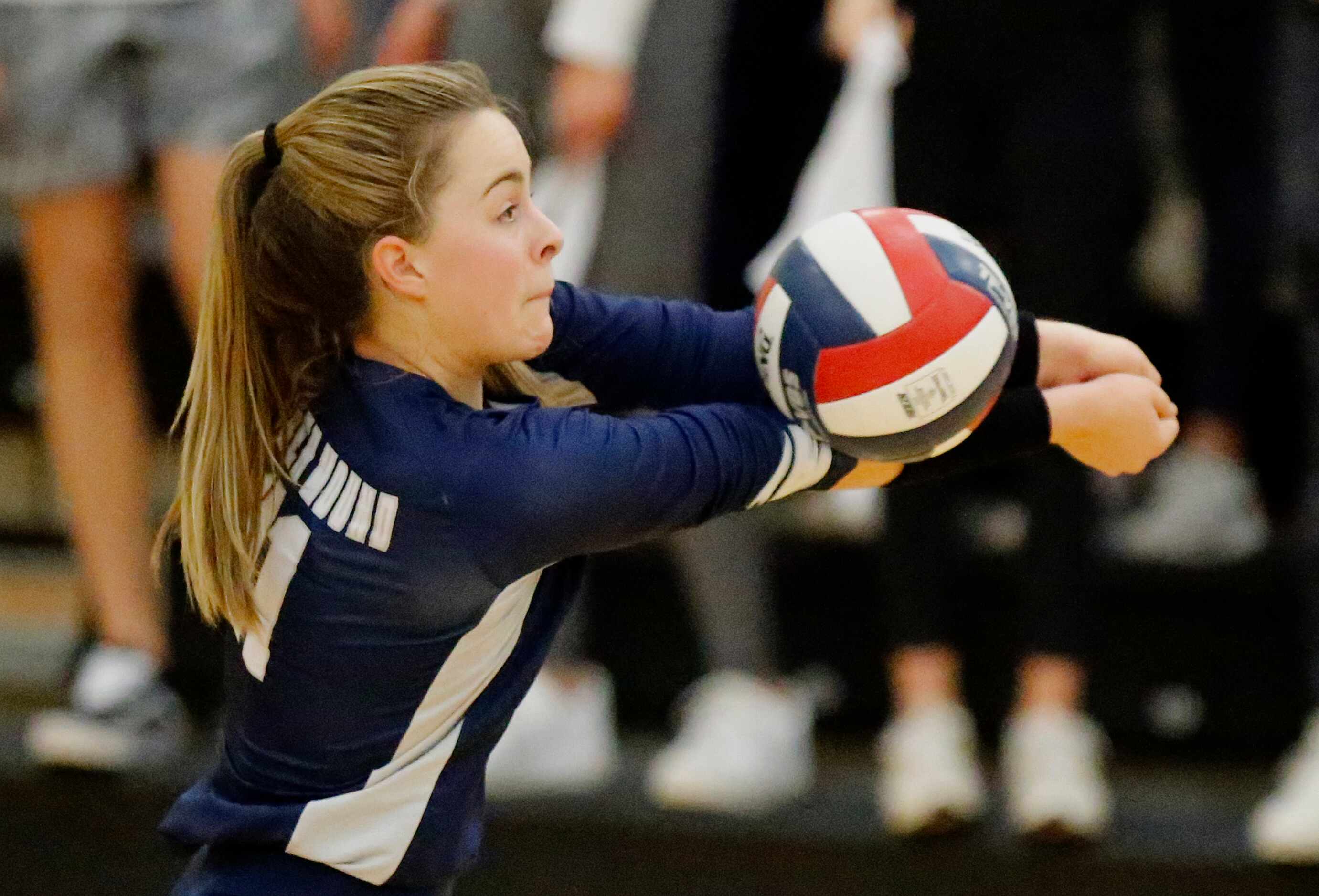 Flower Mound High School outside hitter Cat Young (11) receives a serve during game two of...