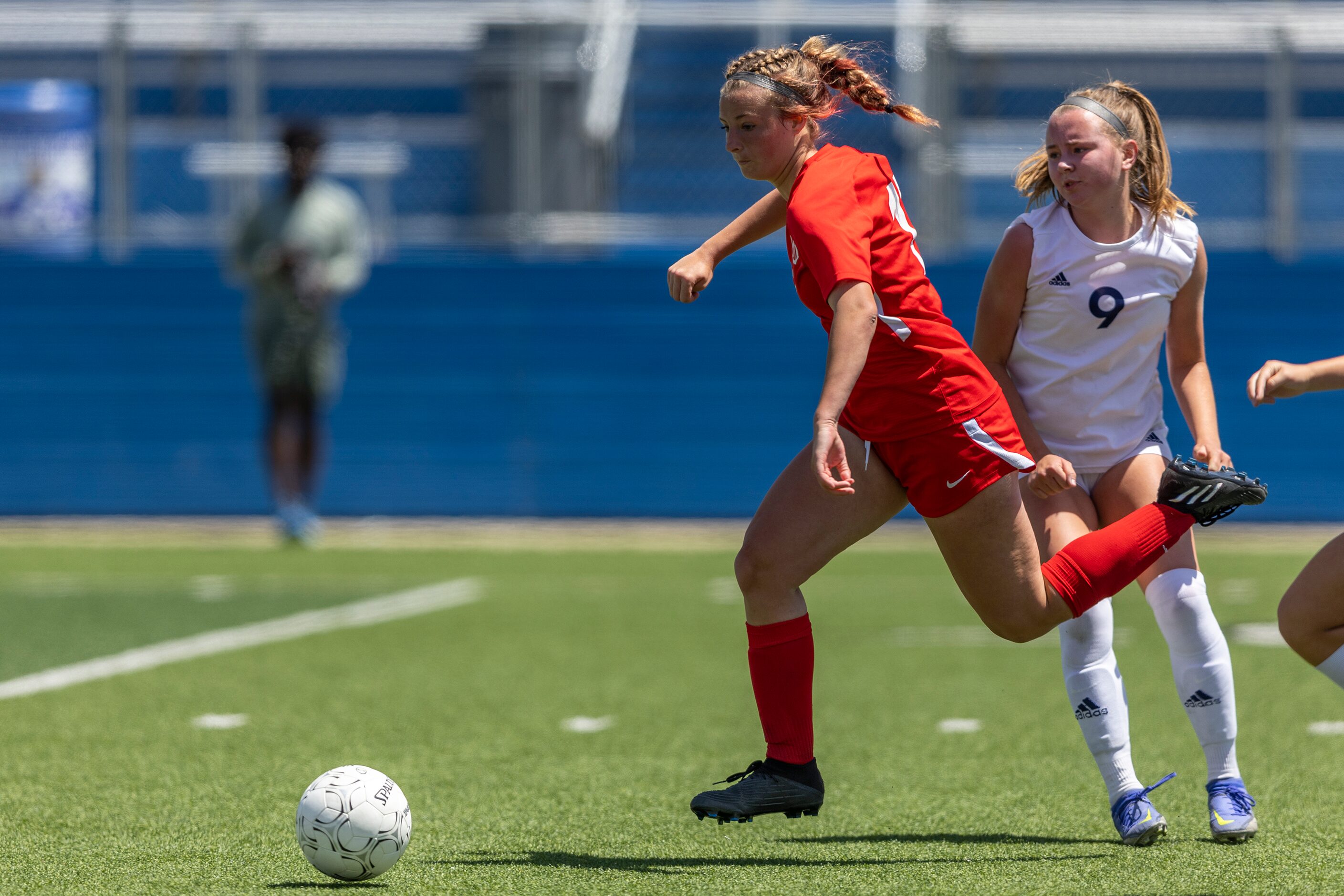 Grapevine midfielder Caroline Martin drives past Boerne Champion defender Grace McClain (9)...