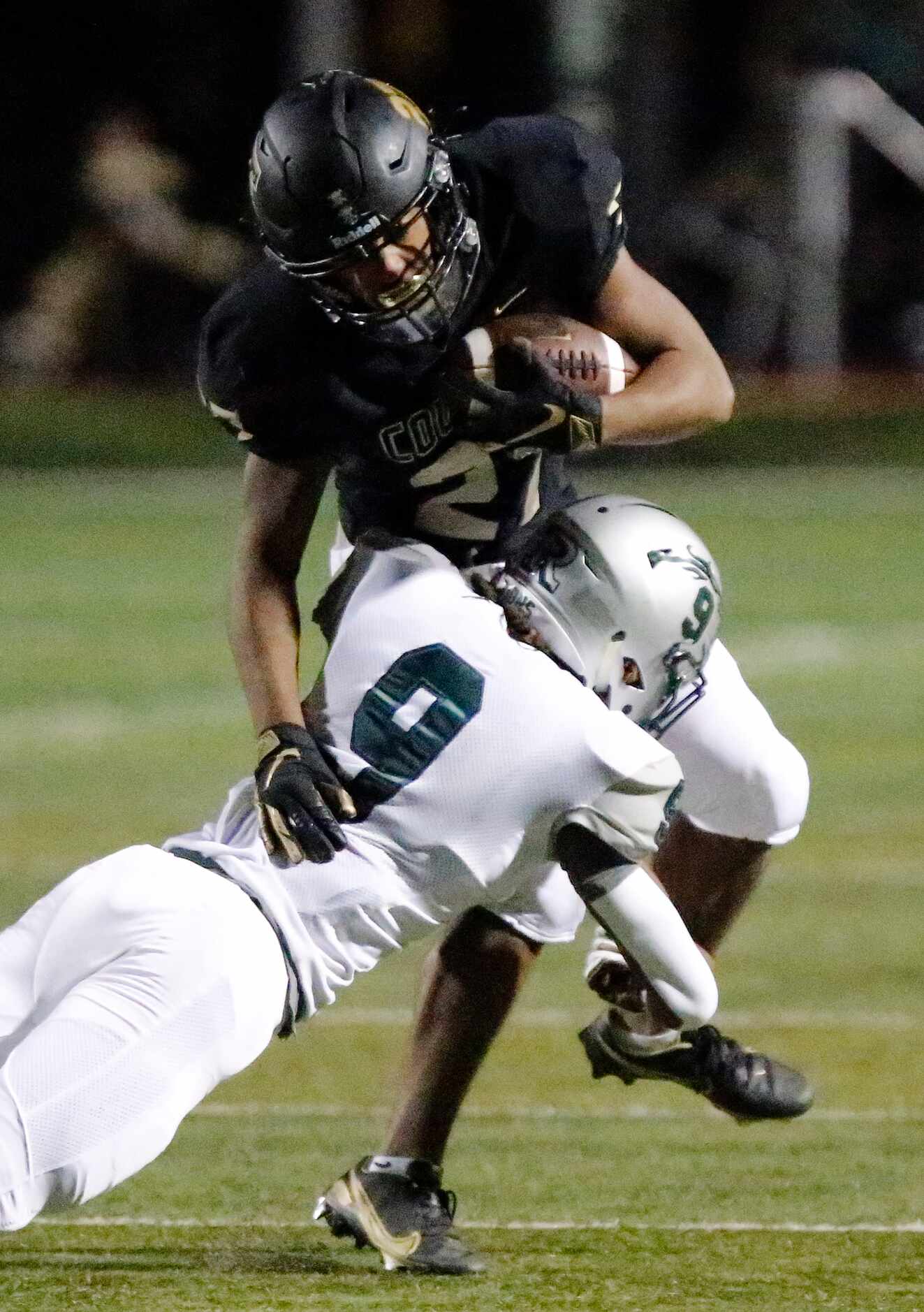 The Colony High School running back Kione Roberson (27) was able to escape this tackle...