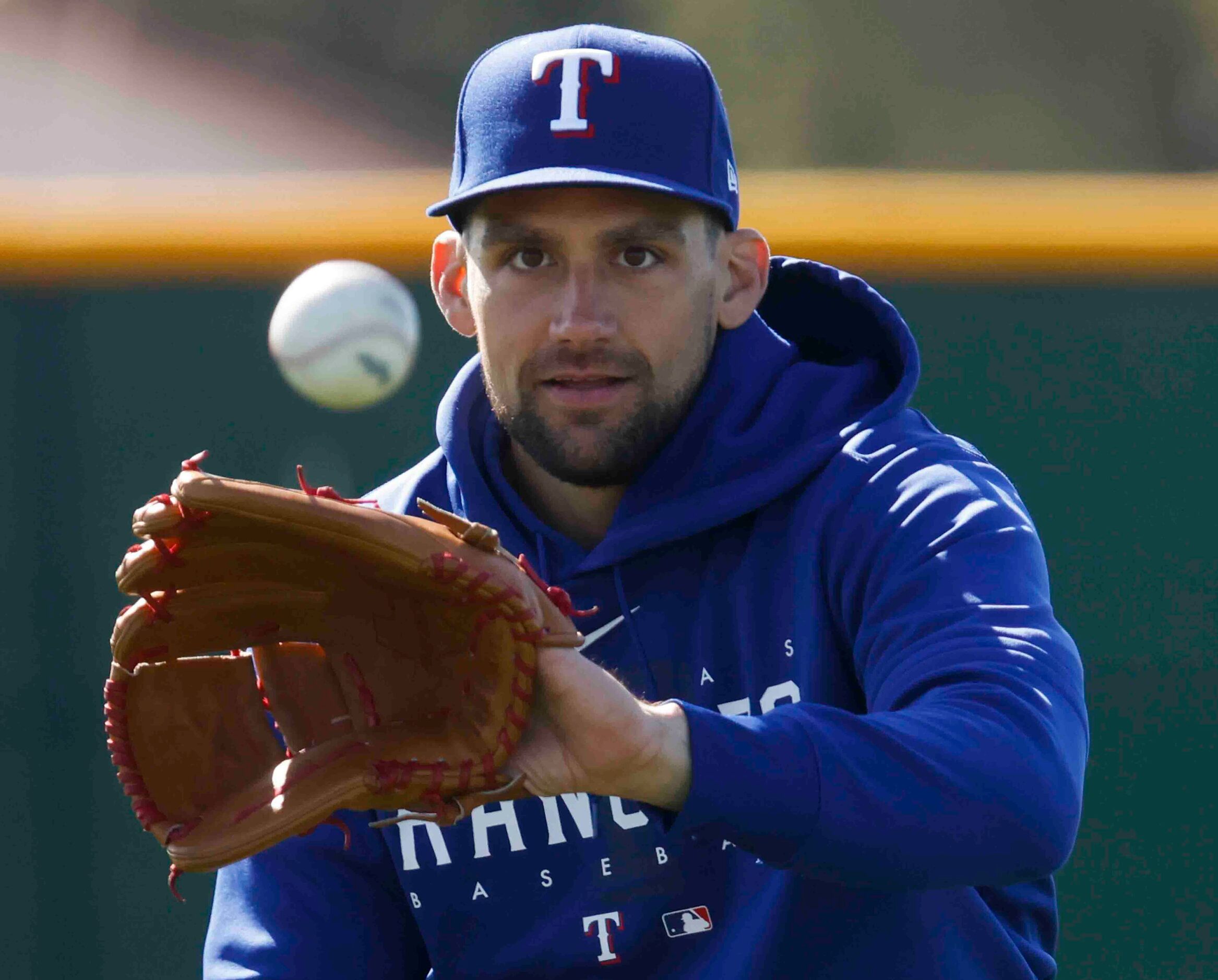 Texas Rangers right handed pitcher Nathan Eovaldi warms up before pitching practice during a...