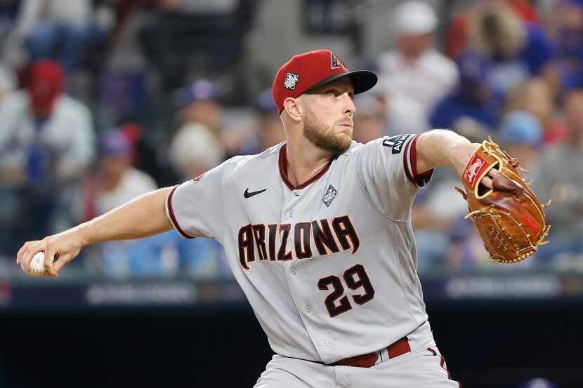 Arizona Diamondbacks starting pitcher Merrill Kelly (29) delivers during the fourth inning...