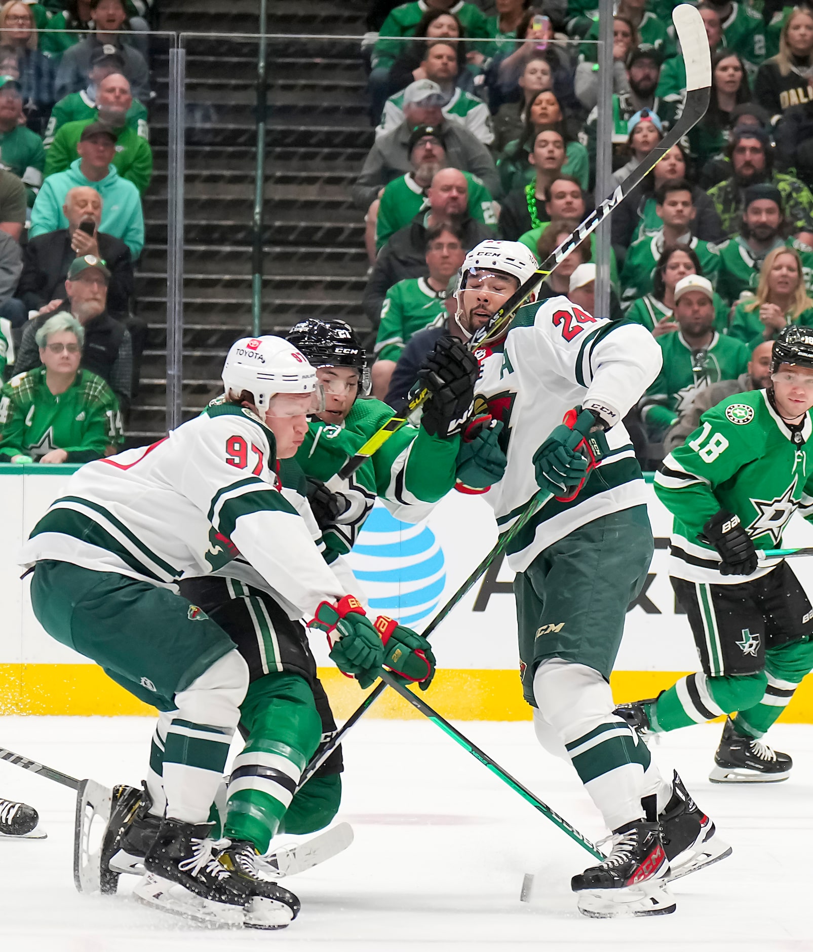 Dallas Stars left wing Jason Robertson (21) loses the puck as he is held up by Minnesota...