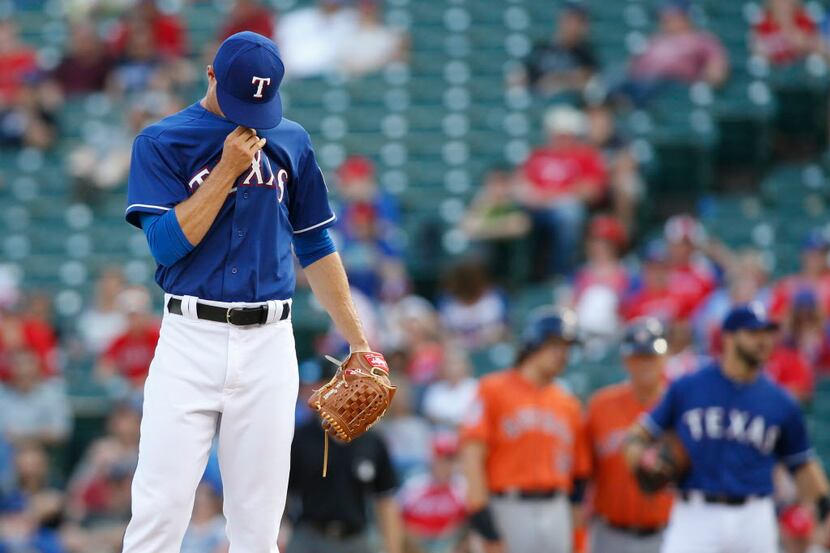 Apr 12, 2015; Arlington, TX, USA; Texas Rangers starting pitcher Logan Verrett (41) reacts...