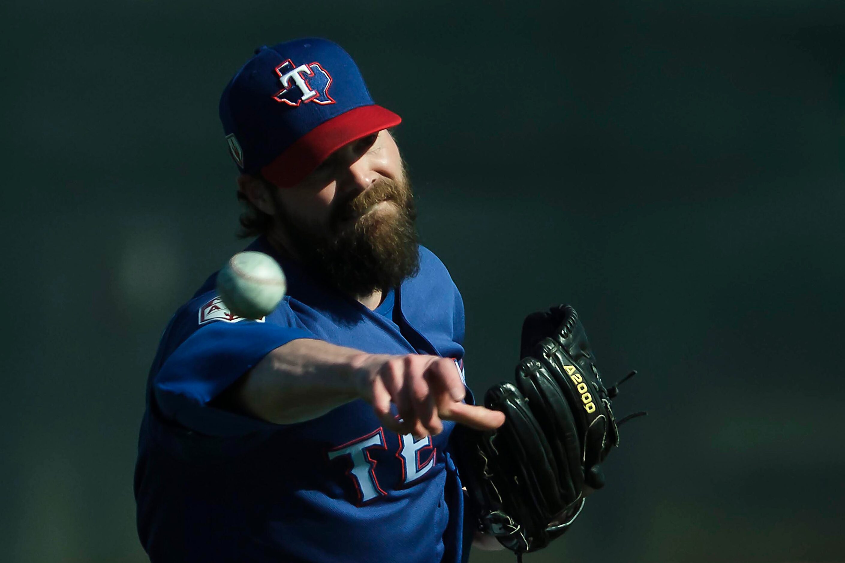 Texas Rangers pitcher Tim Dillard throws in the outfield during a spring training workout at...