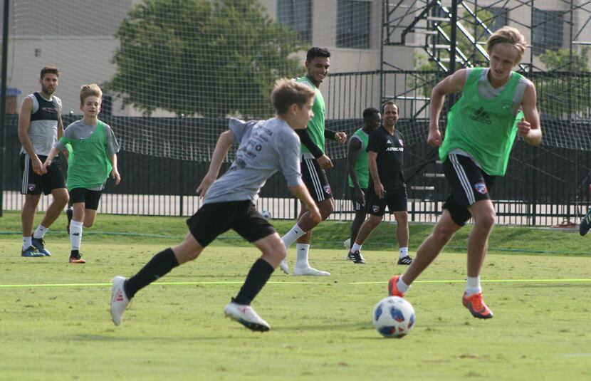 Thomas Roberts (foreground in green) plays defense against one of the two FC Dallas summer...