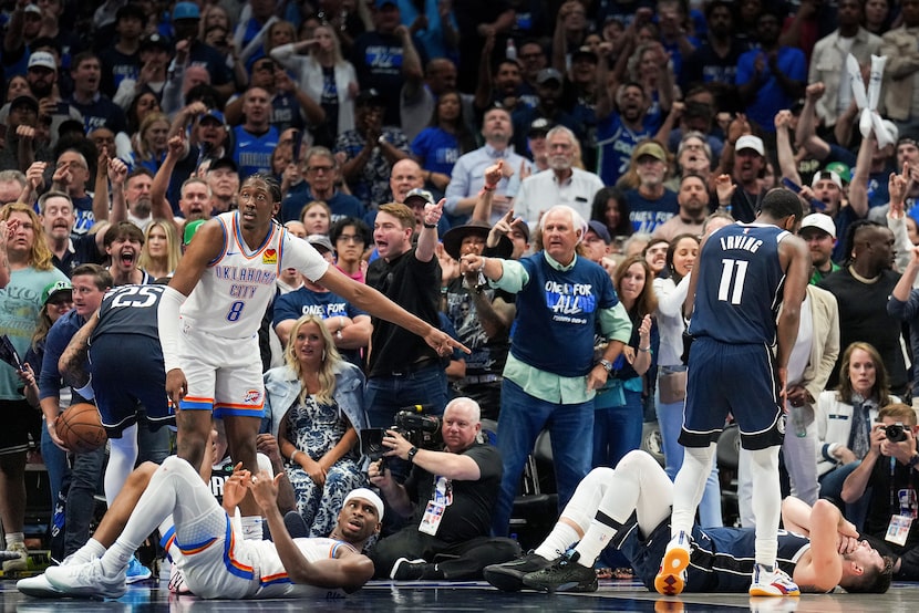 Dallas Mavericks guard Luka Doncic (77) lies on the floor after drawing a charge on a drive...