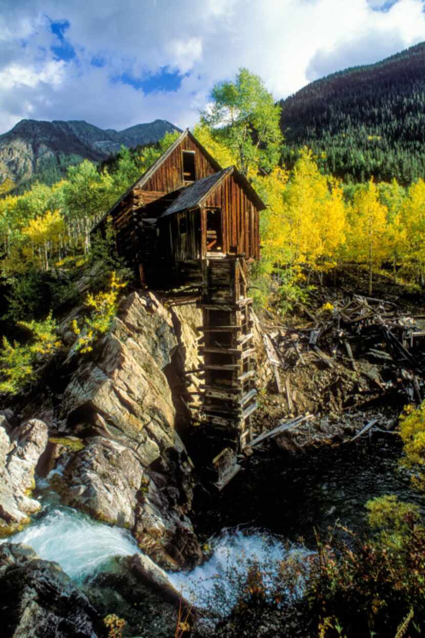 The remains of what's now known as the Crystal Mill stand above a cascading waterfall in the...