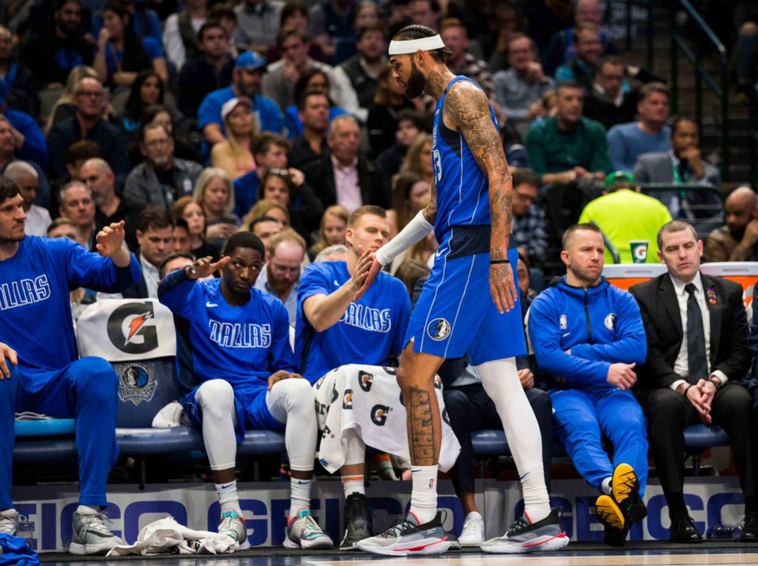 Dallas Mavericks center Willie Cauley-Stein (33) high-fives forward Kristaps Porzingis (6)...