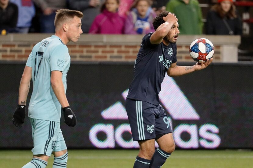 FC Cincinnati midfielder Kenny Saief, right, reacts alongside Real Salt Lake forward Corey...