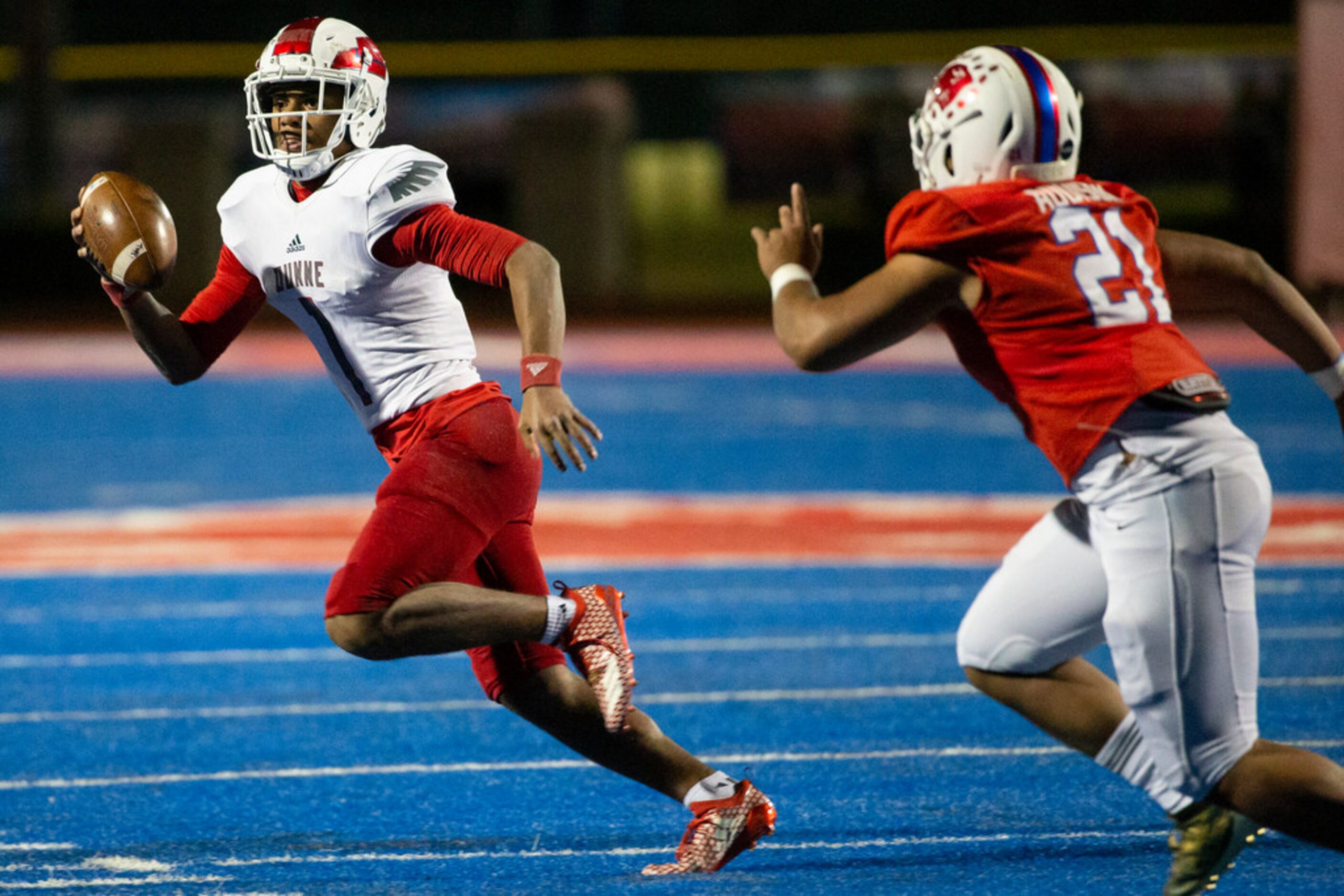 Bishop Dunne quarterback Simeon Evans (1) attempts to evade Parish Episcopal line backer...