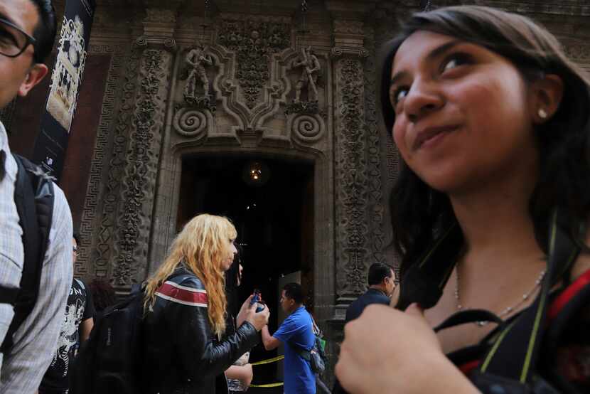 People pass by the Palace of Iturbide on Madero Street in Mexico City. A project led by two...