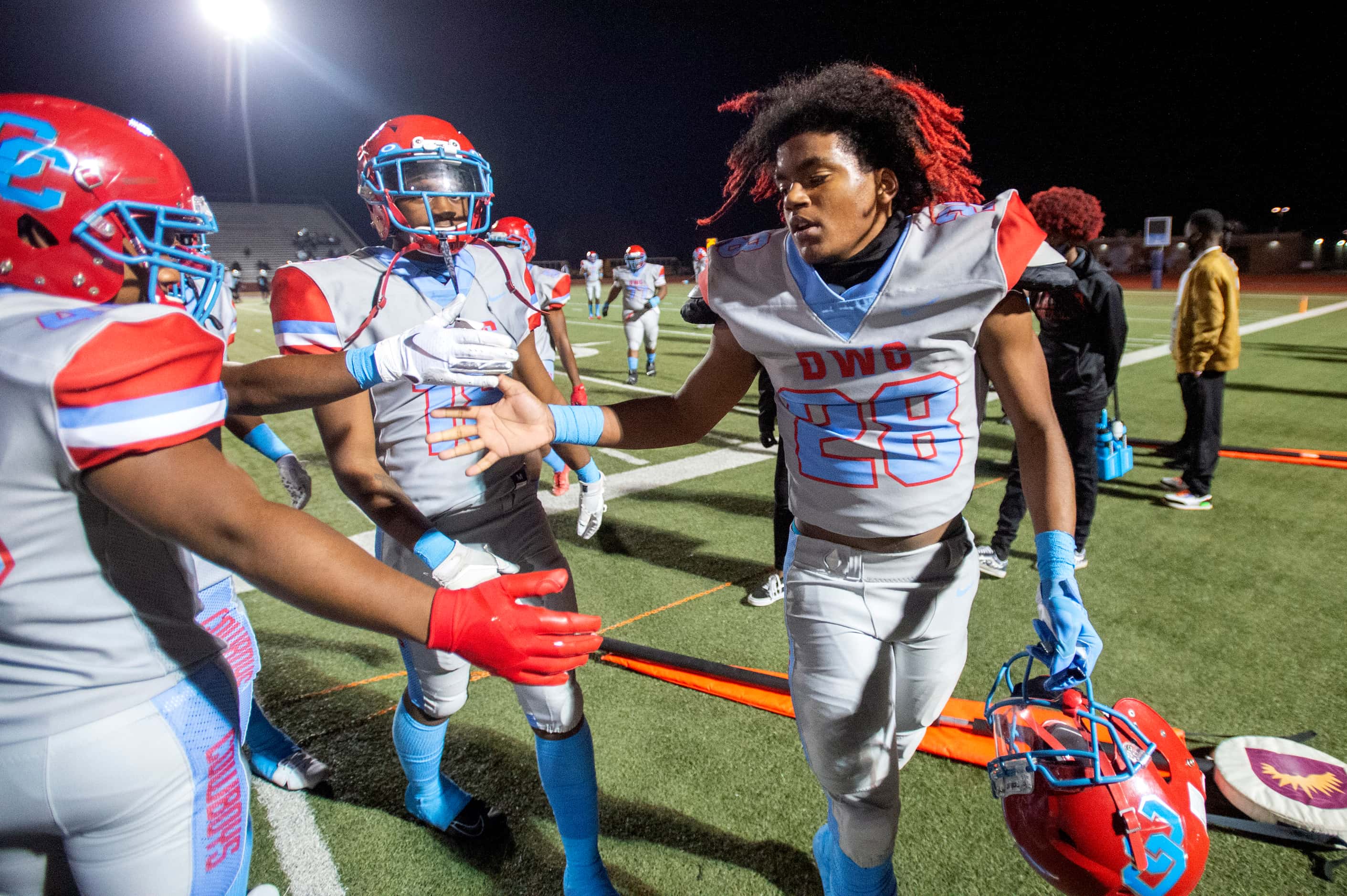 Carter junior running back Edward Robinson (28) is congratulated by teammates after a...