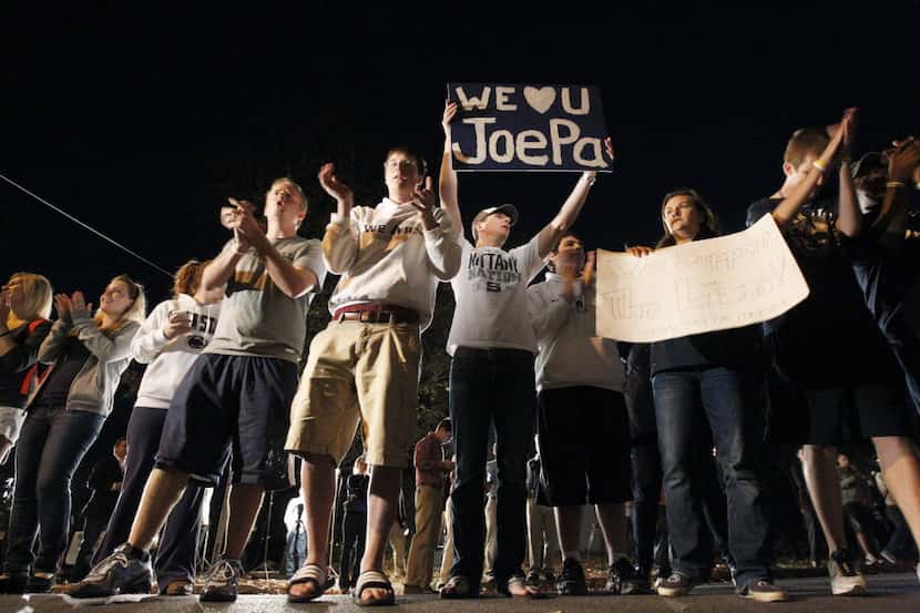 Students rally in support of Penn State football coach Joe Paterno before he arrives at his...
