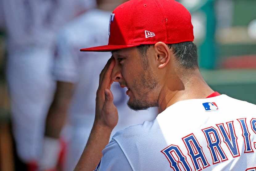 Texas Rangers starting pitcher Yu Darvish (11) wipes sweats off his face in the dugout...