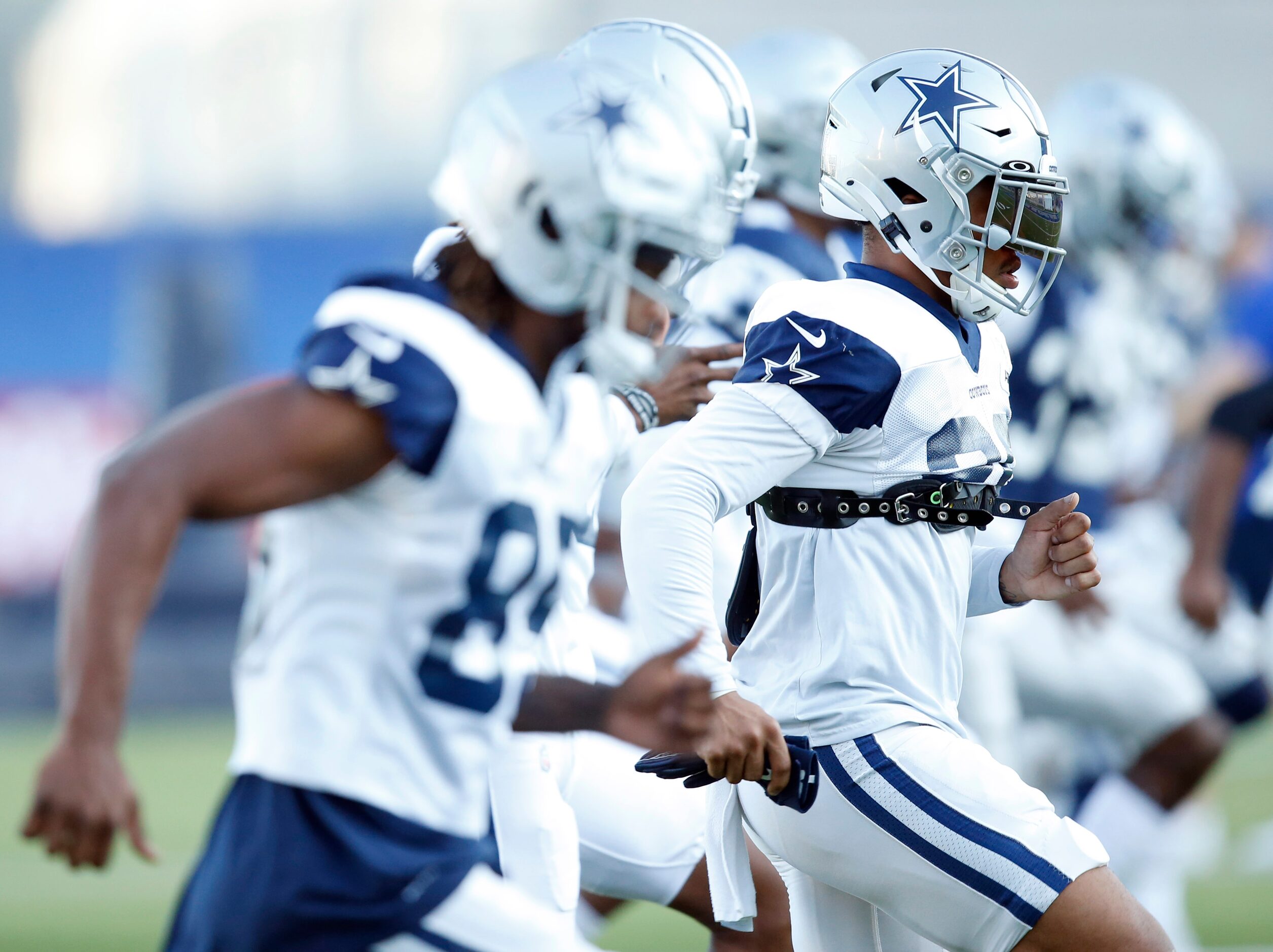 Dallas Cowboys running back Tony Pollard (20) stretches with teammates in practice during...