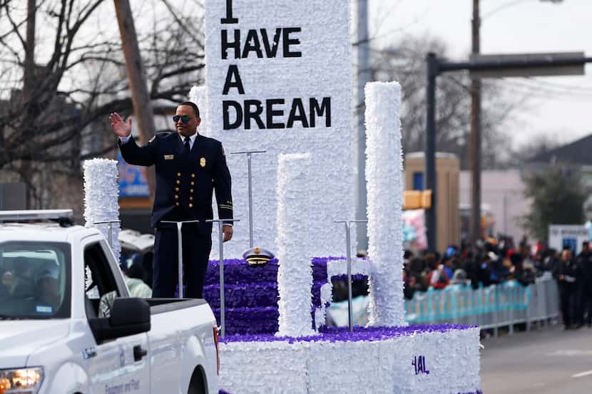 Dallas Fire-Rescue Chief Dominique Artis, grand marshall waves to the people as they make...