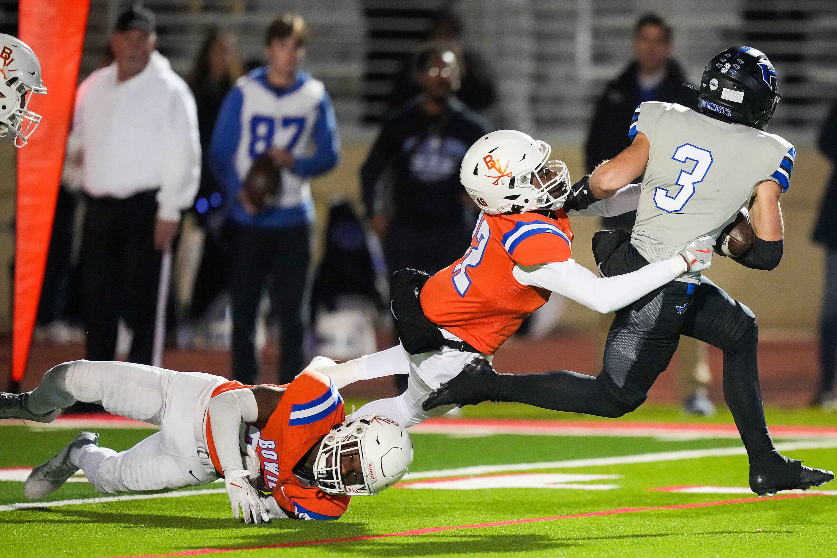 Hebron wide receiver Drew Koster (3) gets past Arlington Bowie’s Kyle Smith (12) and...