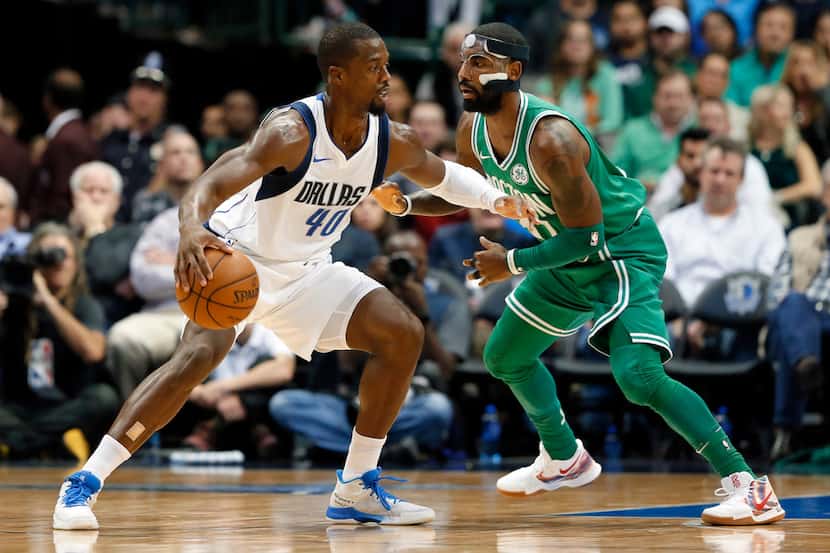 Harrison Barnes works against Boston Celtics' Kyrie Irving for a shot in the second half of...