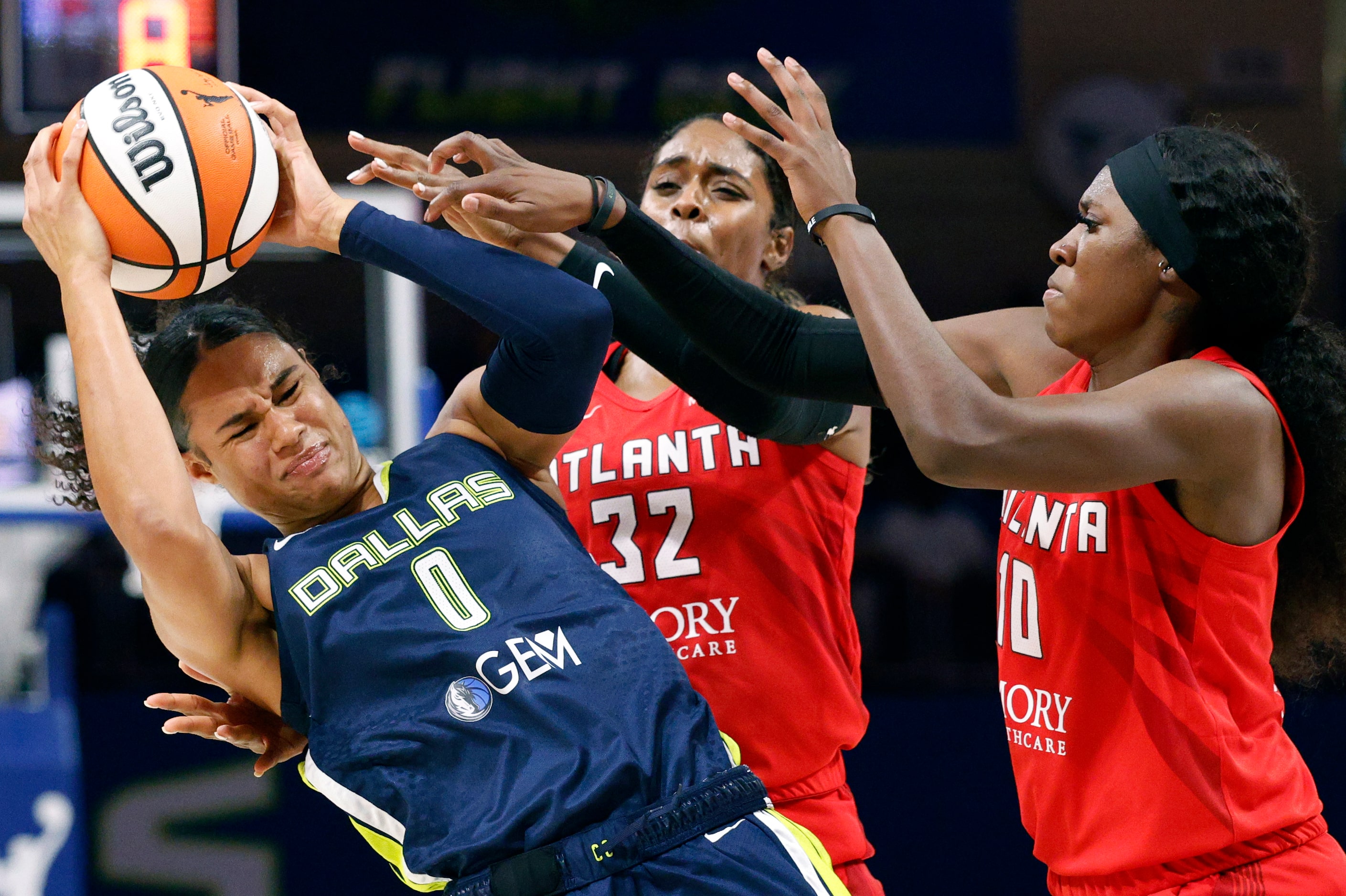 Dallas Wings forward Satou Sabally (0) holds the ball under pressure from Atlanta Dream...