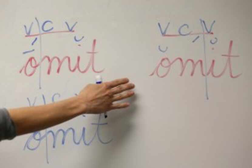  Teacher Lisa Hamilton decodes a word with students during a multisensory approach class at...