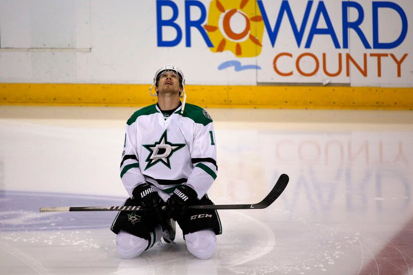Dallas Stars left wing Curtis McKenzie stretches out during warmups before the start of an...