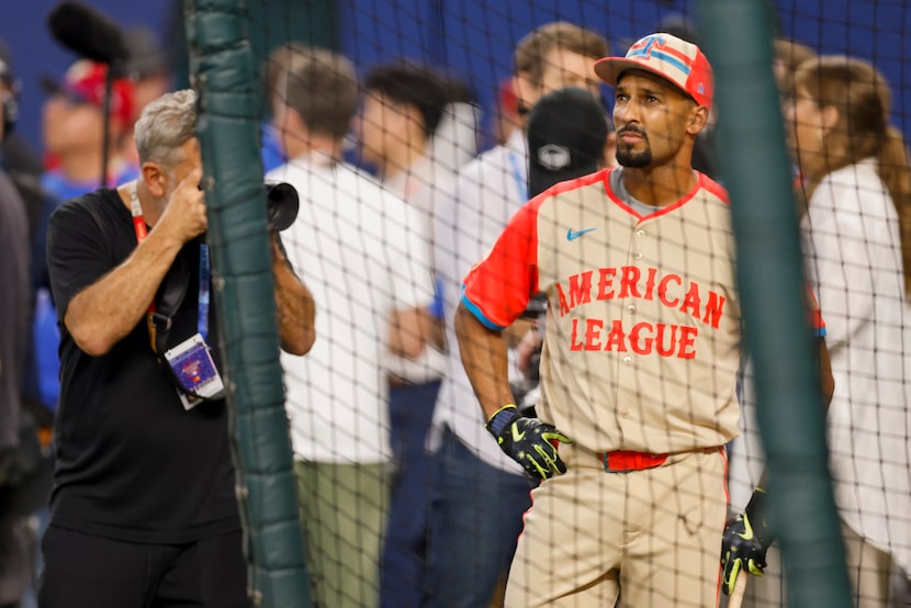 American League's Marcus Semien, of the Texas Rangers, watches batting practice before the...