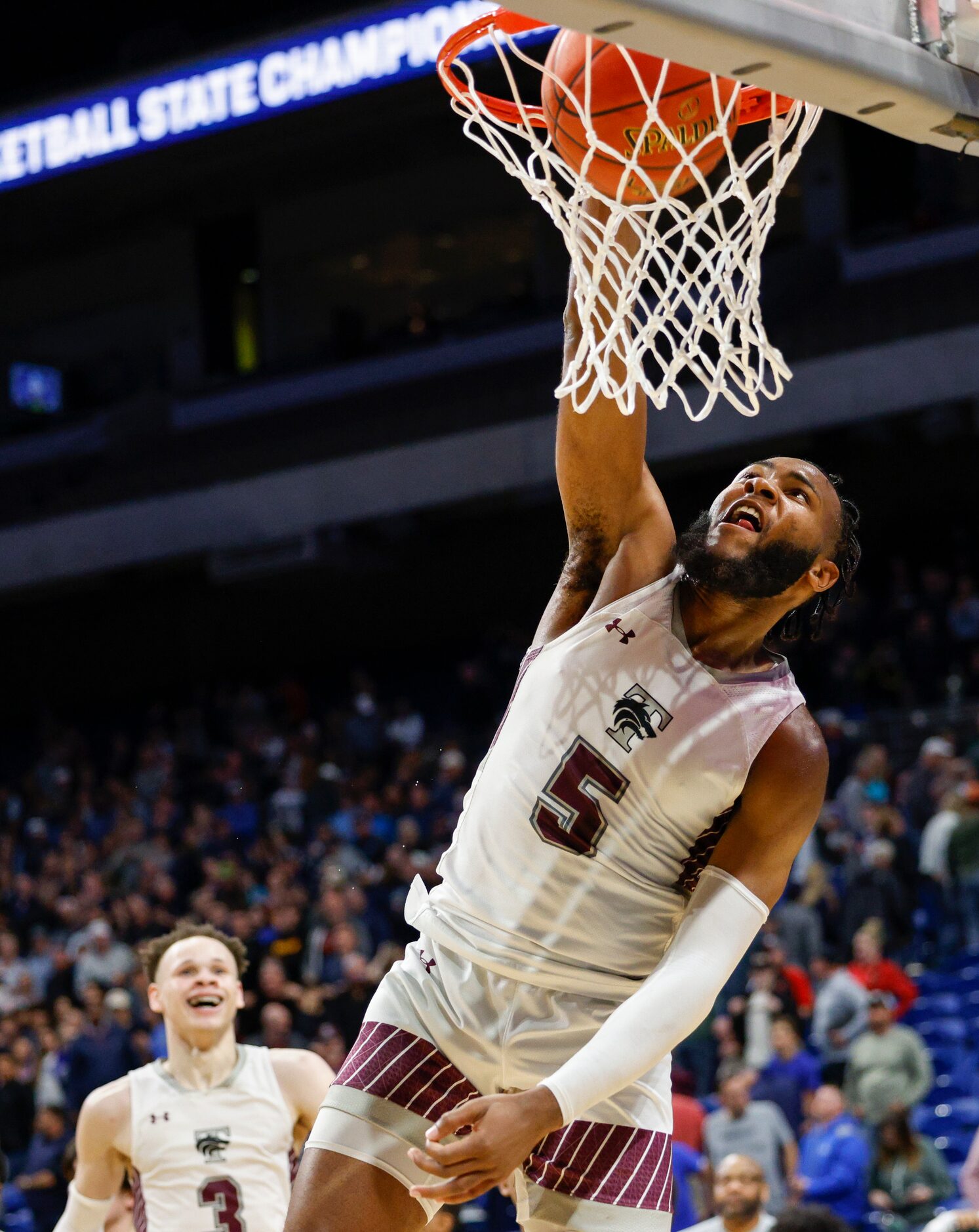 Mansfield Timberview guard Jared Washington (5) celebrates with a dunk after defeating...