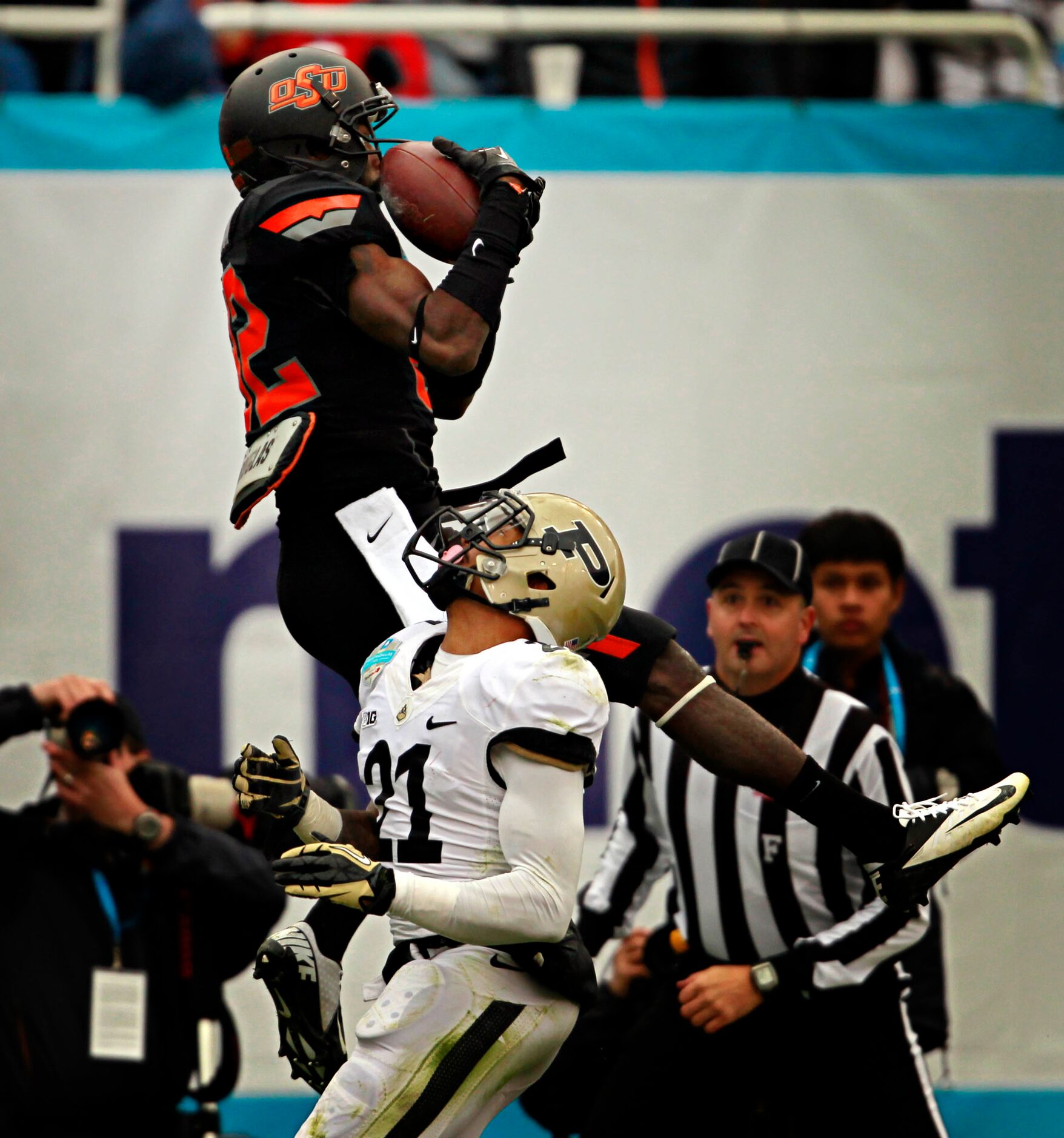 Oklahoma State Cowboys wide receiver Isaiah Anderson (82) jumps above Purdue Boilermakers...