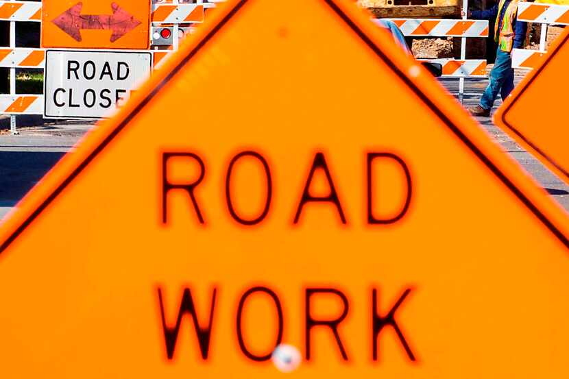 Signs point the way to a detour as crews work on street construction. (Smiley N. Pool/The...