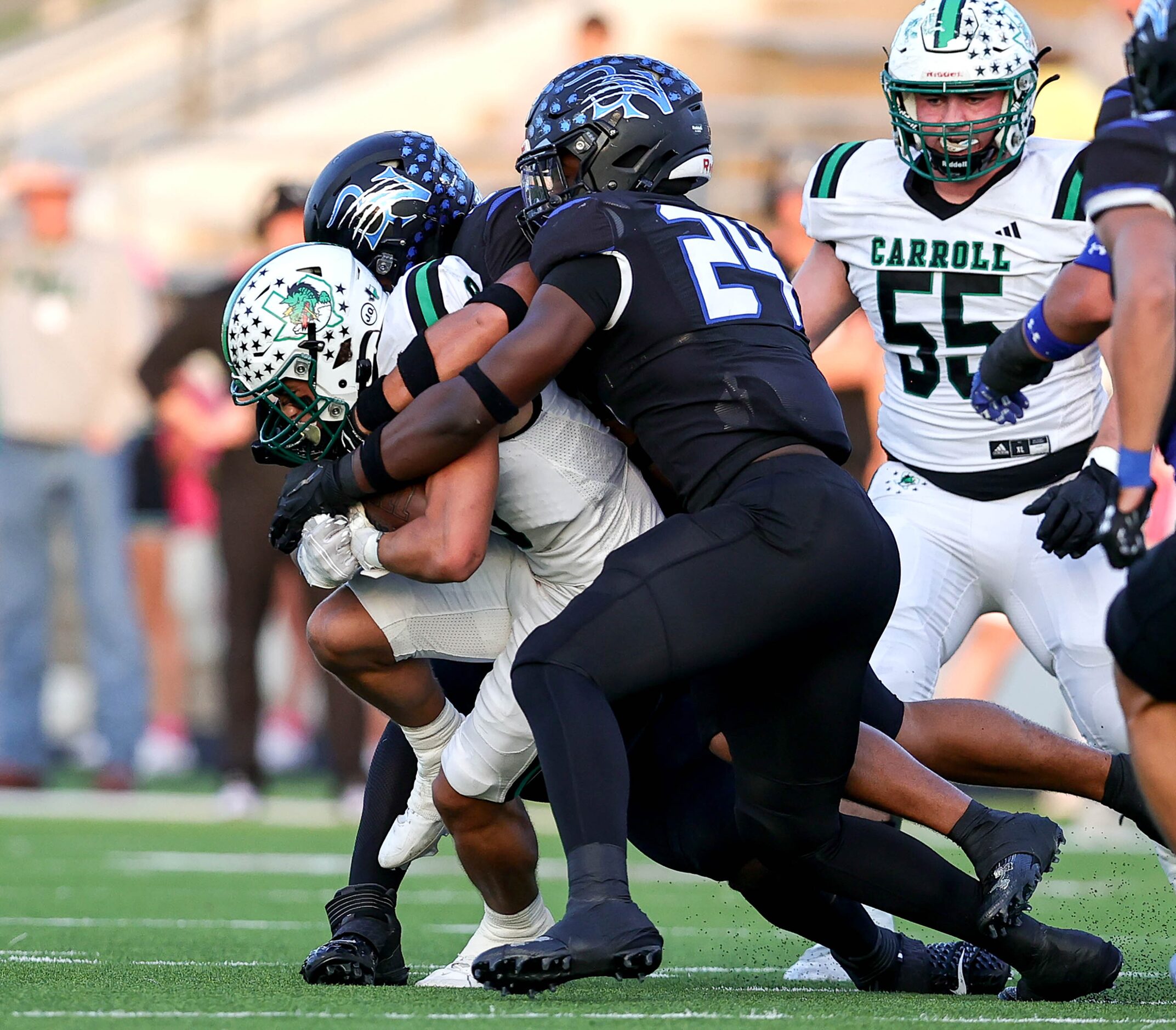 Southlake Carroll running back Riley Wormley (left) gets stuffed by Byron Nelson linebacker...