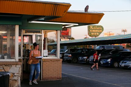 Jamie Lynn (left) and Nikki Hood deliver food to cars at Keller's Drive-In in Dallas in this...