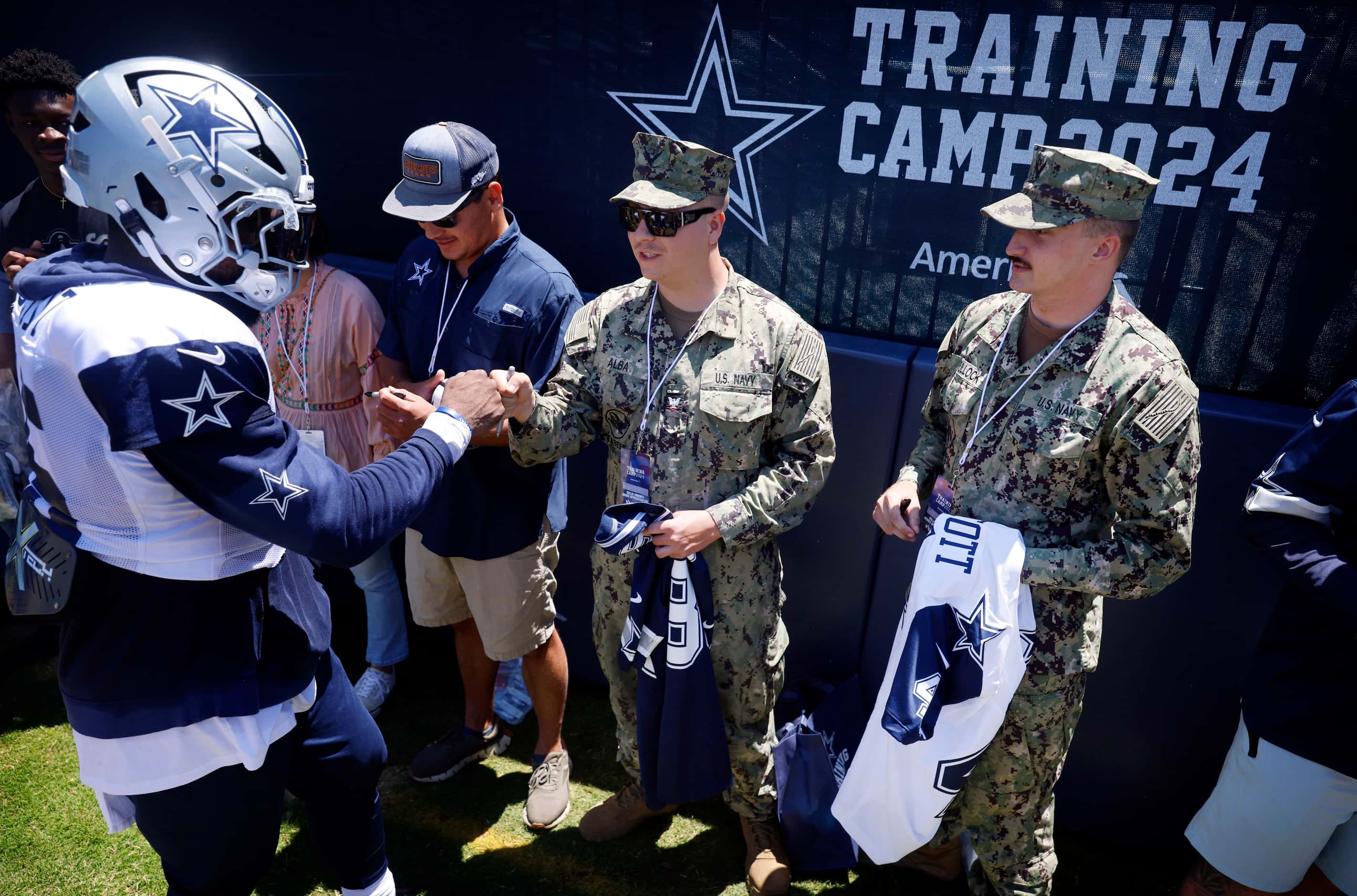 Dallas Cowboys running back Ezekiel Elliott (15) fist bumps Naval Builder Third Classmen...
